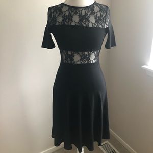 Black cocktail dress with mesh/lace inserts